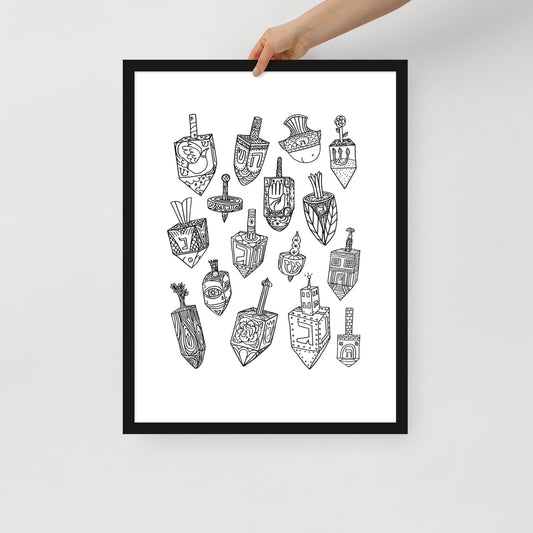 A hand holding the Meshugge dreidel poster to show the scale of the frame