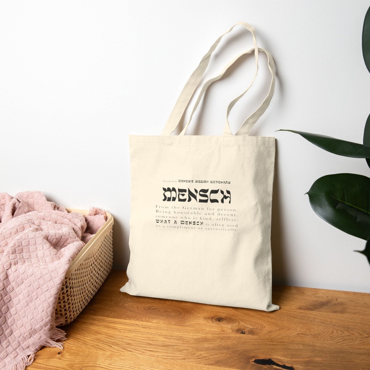 Beige Mensch tote bag lying against the wall