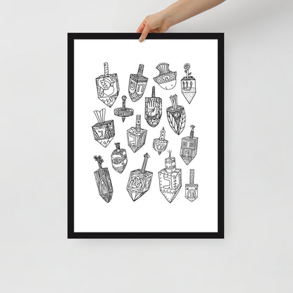 A hand holding the Meshugge dreidel poster to show the scale of the frame