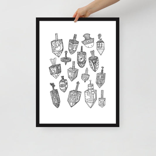 A hand holding the Meshugge dreidel poster to show the scale of the frame