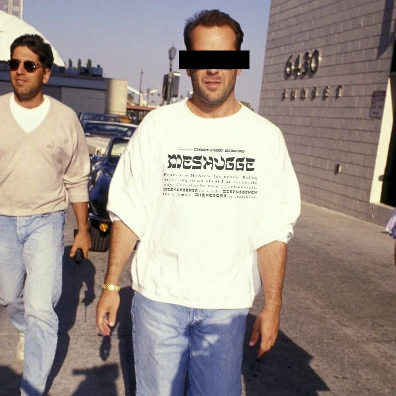 Man wearing a white Meshugge definition sweatshirt on the streets of Los Angeles 
