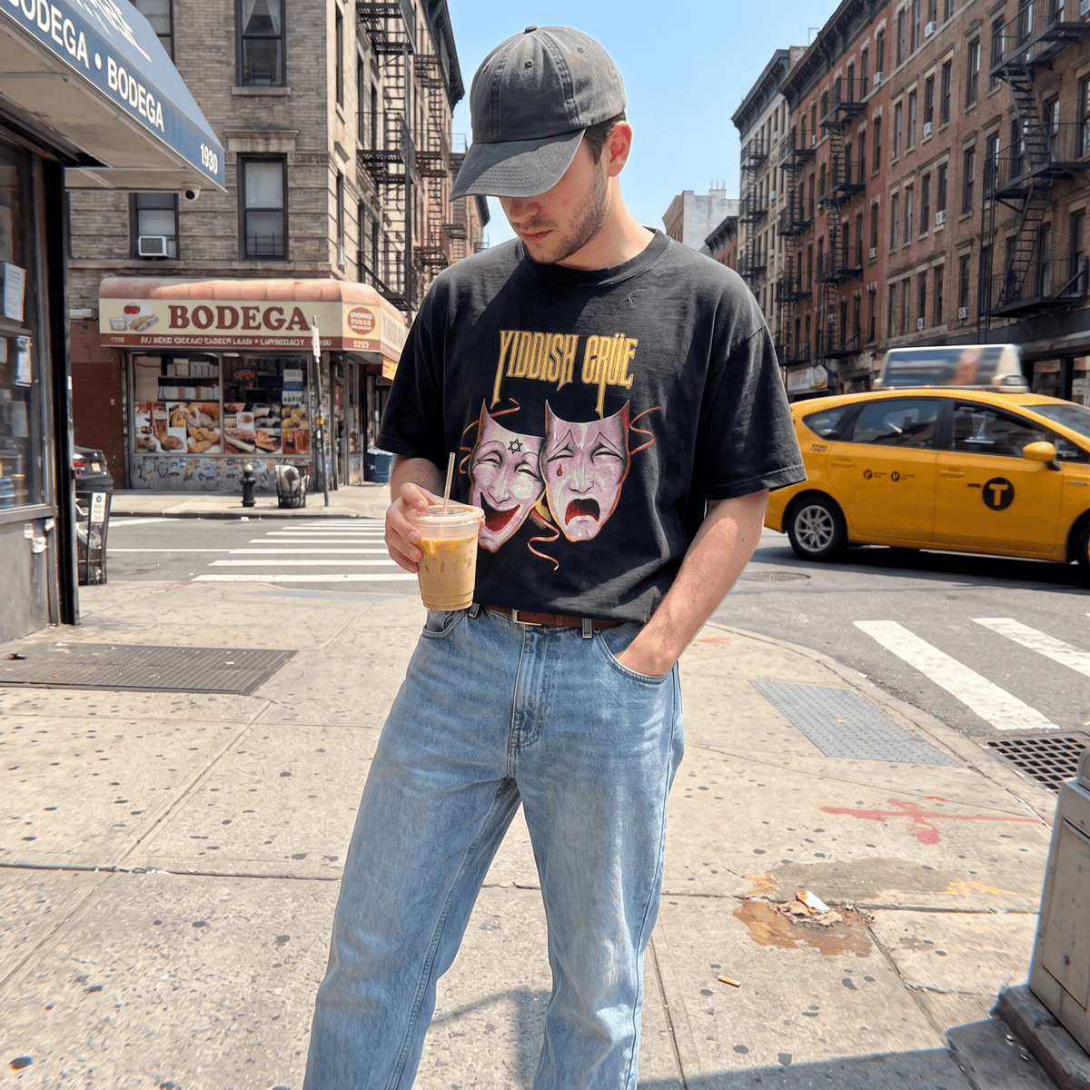 A man wearing the Yiddish Crüe graphic T-shirt by Meshugge in the streets of New York 