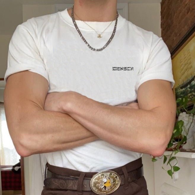Man wearing white Mensch T-shirt