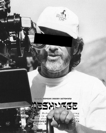 Man operating a camera, wearing a white Meshugge definition sweatshirt, black and white picture