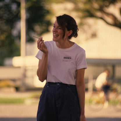 Woman smoking wearing mensch heart t-shirt in white