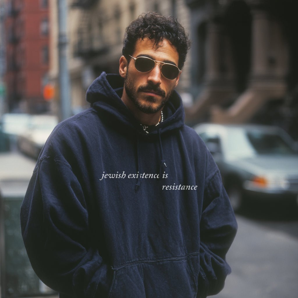 man wearing Jewish Existence Is Resistance hoodie navy