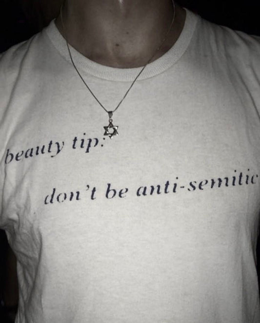 man wearing a "Beauty Tip: Don't be anti-Semitic" T-shirt