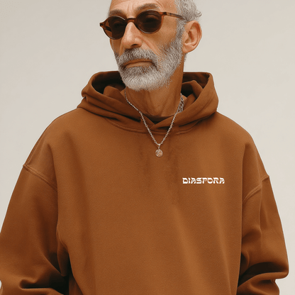 older man wearing the Diaspora hoodie in brown
